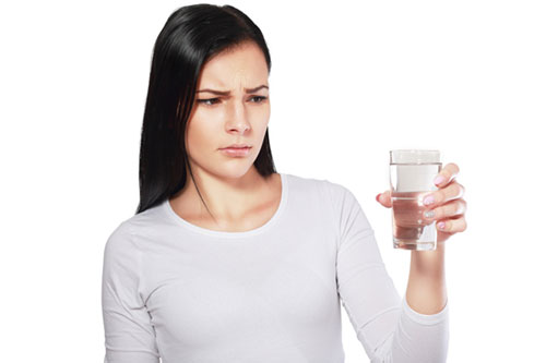 woman looking at water looking unhappy or disgusted